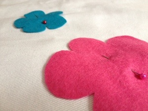 Pinning on the felt flowers.