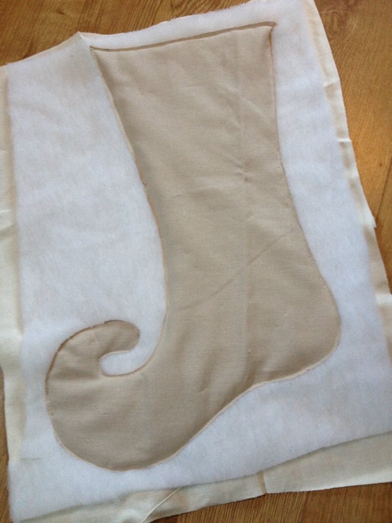 A long machine running stitch made around the stocking shape outside where my seam would be sown to piece the layers together.